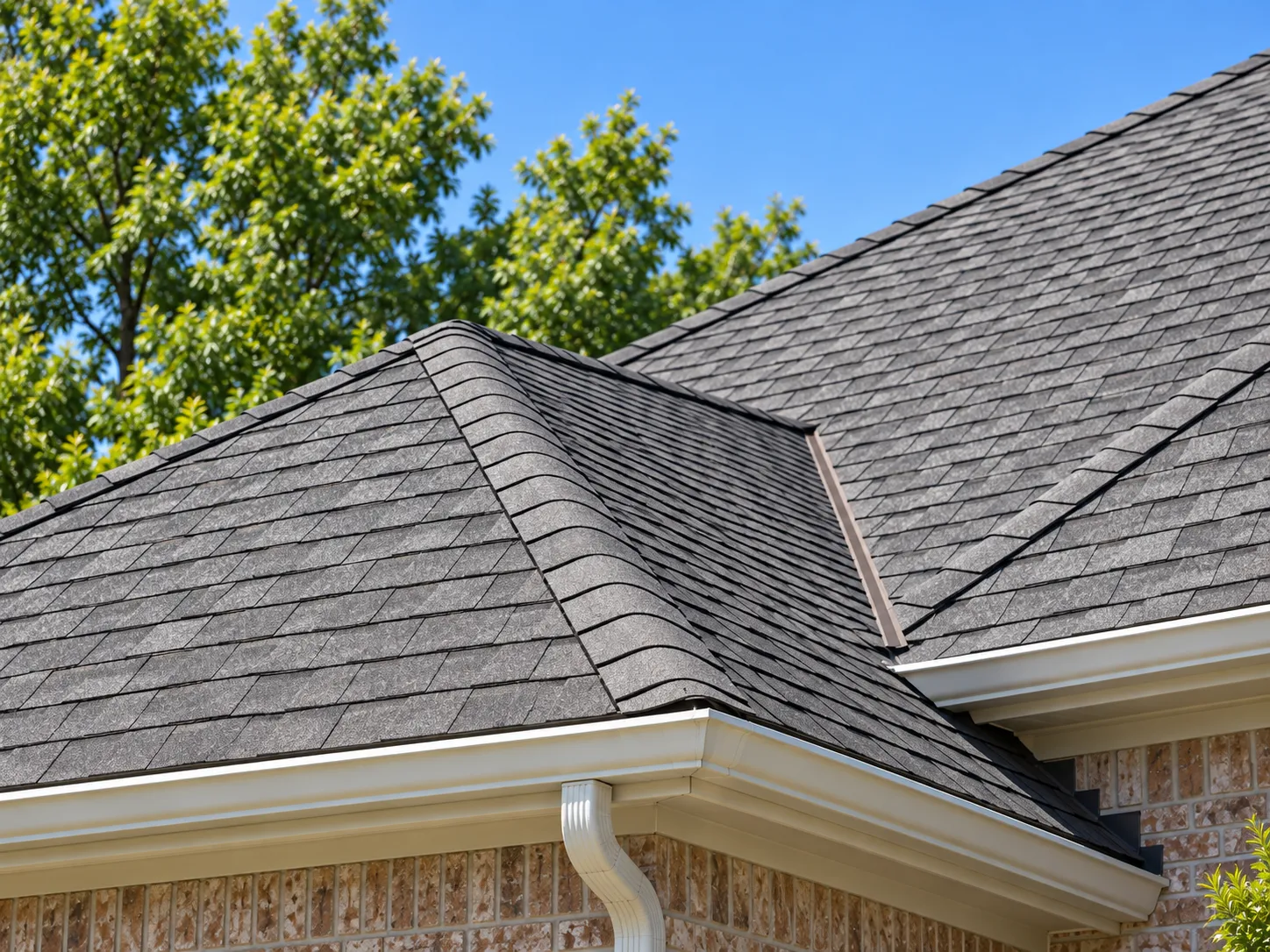 Close-up of architectural roof shingles and a rain gutter